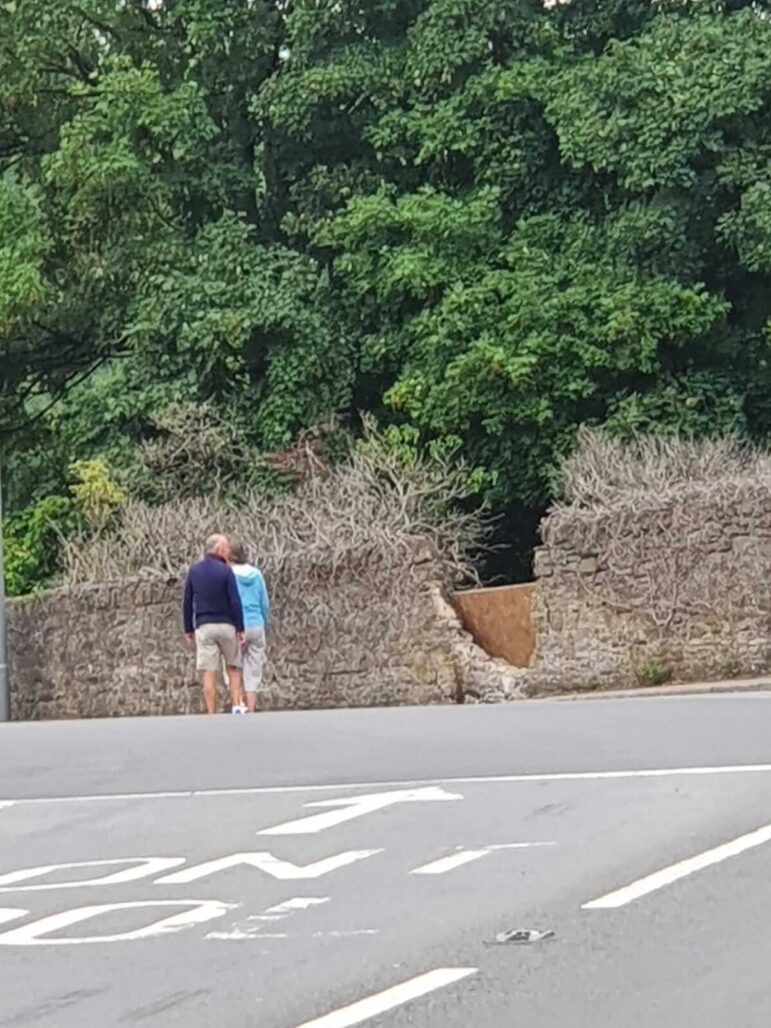 A hole in a wall where a car crashed