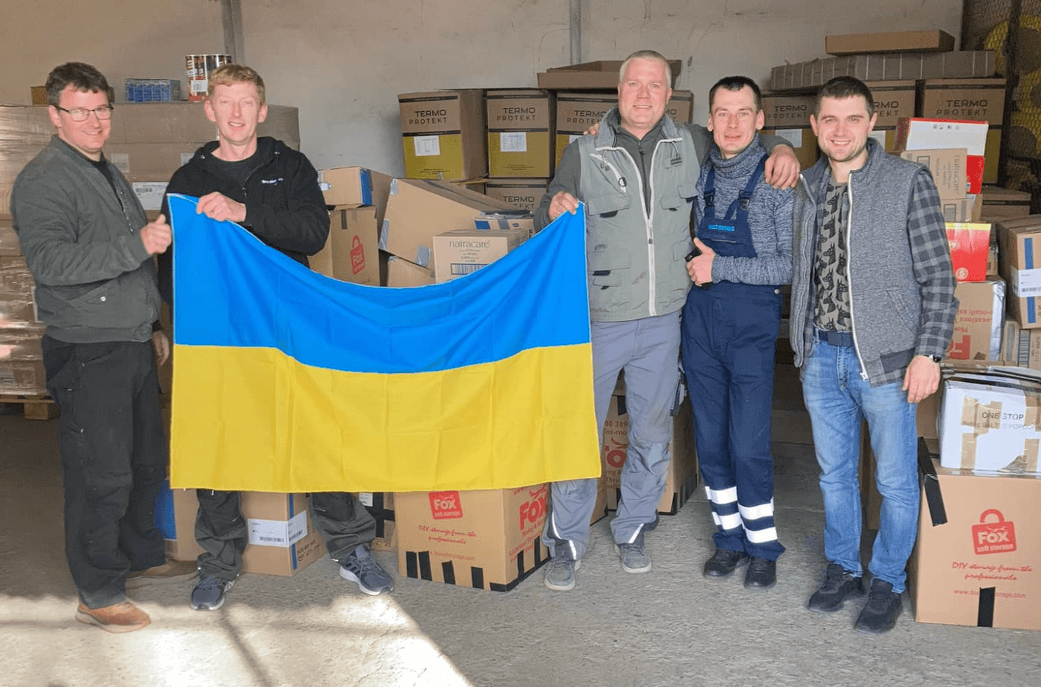 5 men hold a Ukraine flag