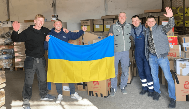 5 men hold a Ukraine flag