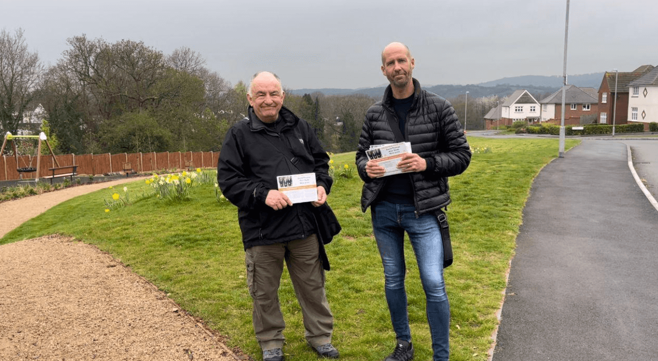 Two men holding election flyers