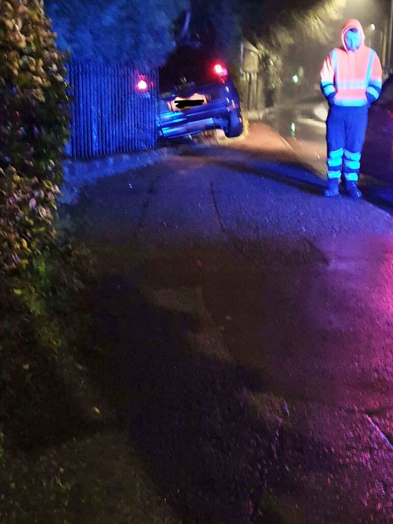 A blue car crashed through railings
