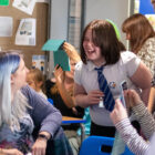 a girl laughs in a classroom