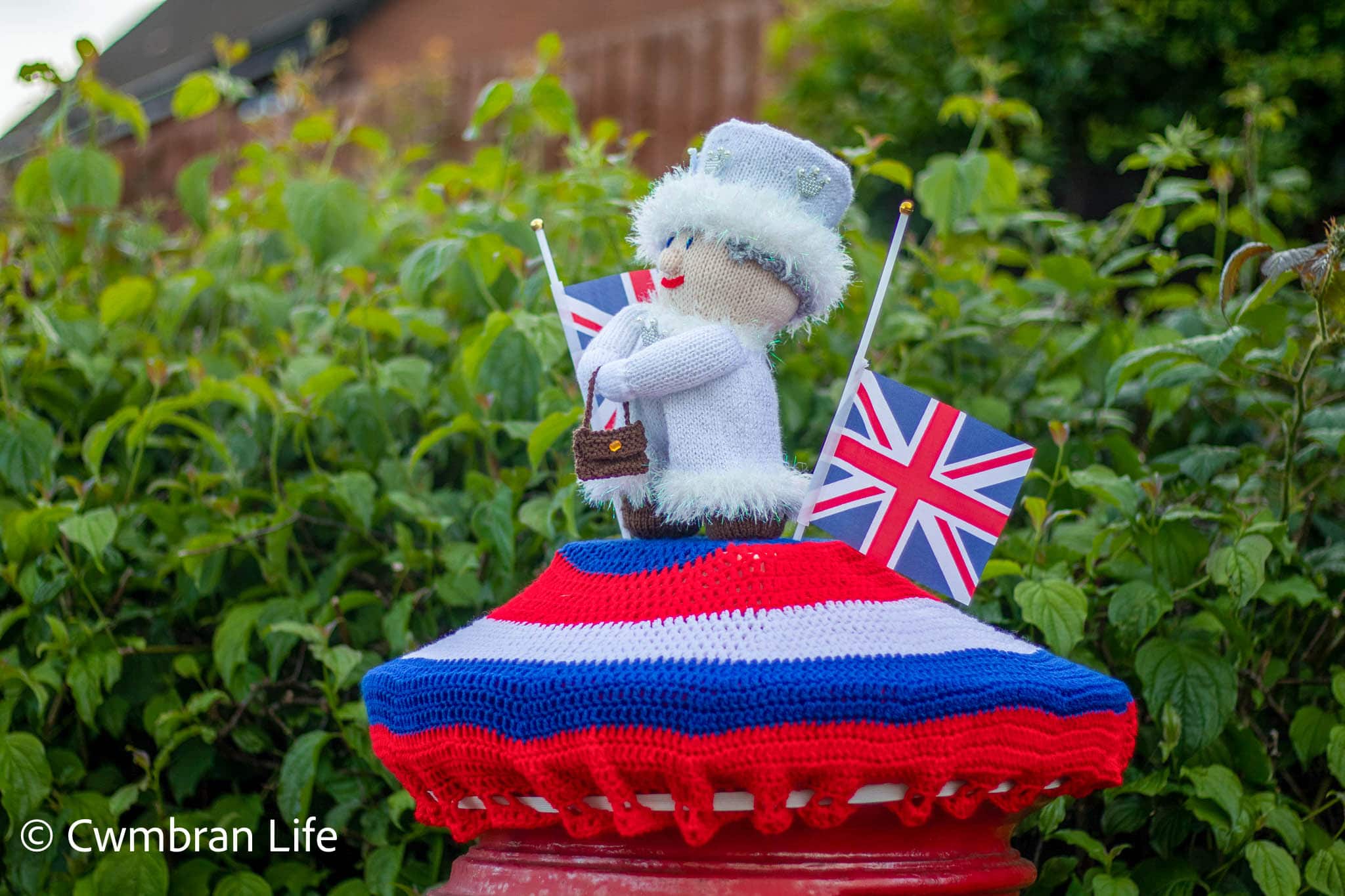 Postbox topped with knitted queen