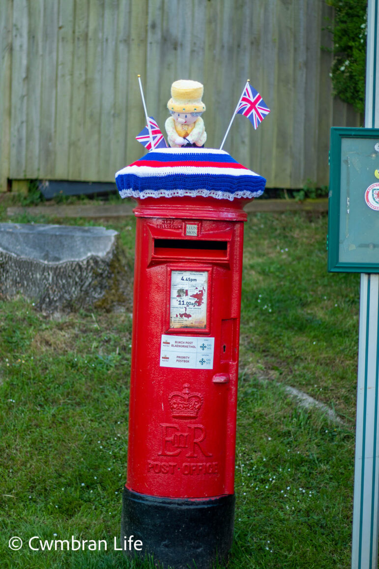 a knitted queen on a postbox