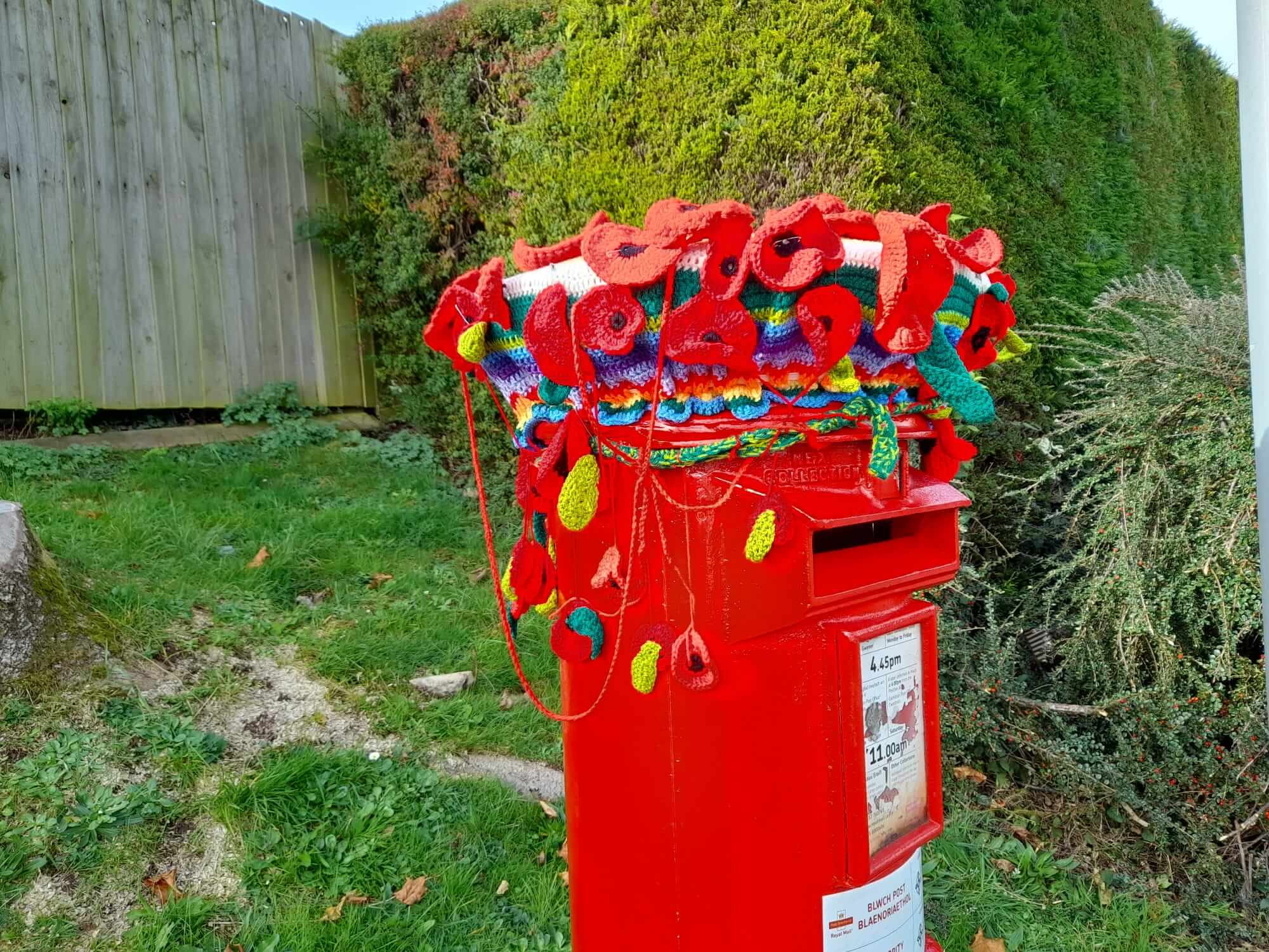 Postbox topped with knitted poppies