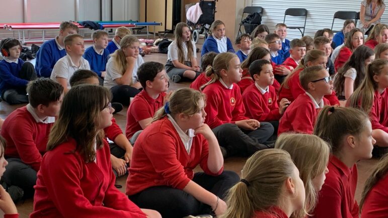 schoolchildren sat in assembly