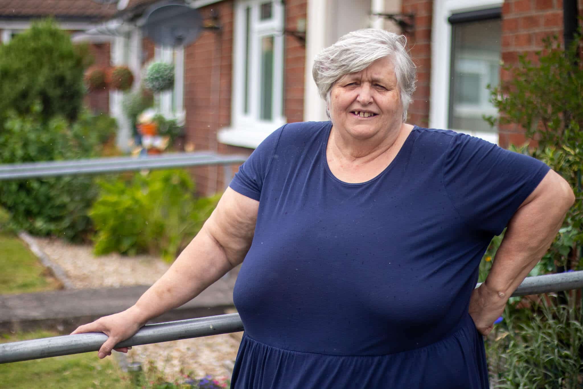 woman stood outside house