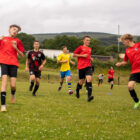 boys running on a football field