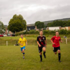 boys sprinting on a football field