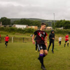 boys running on a football pitch