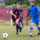 two teenagers compete for a football