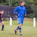 a teenage boy kicking a football