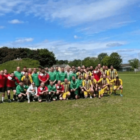 two football teams stand together