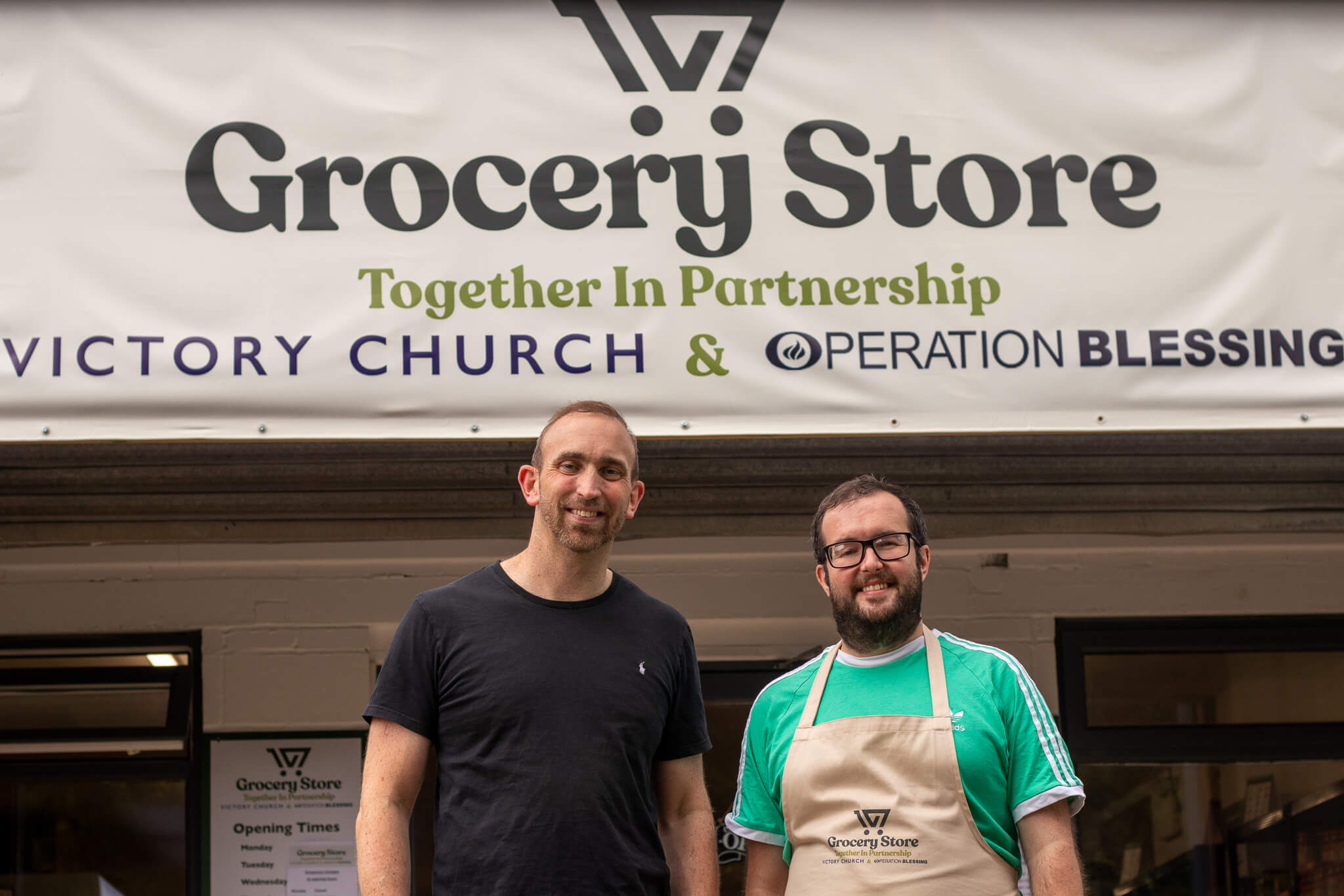 two men outside a grocery store
