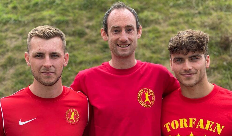 three men in red t-shirts