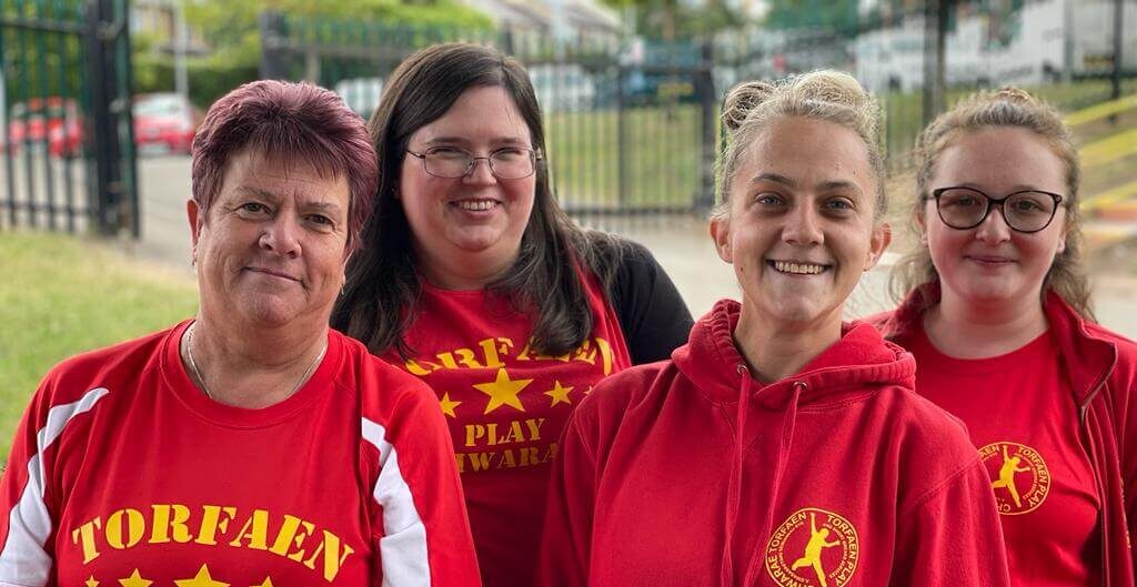 four women in red t-shirts