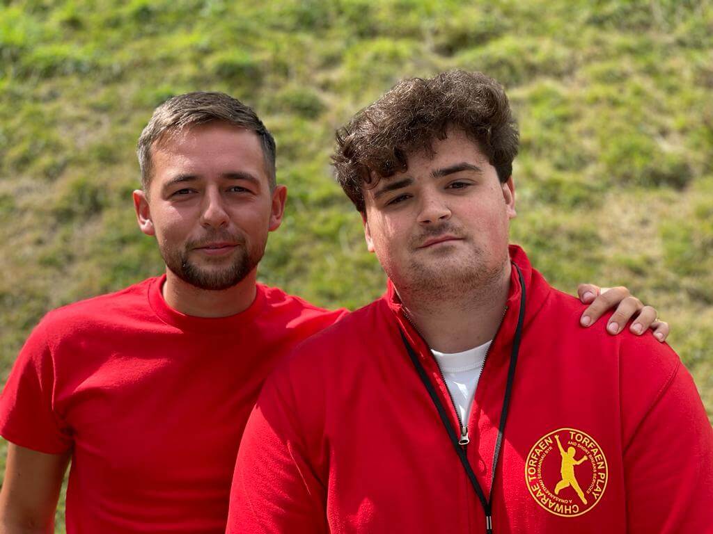 two men in red t-shirts