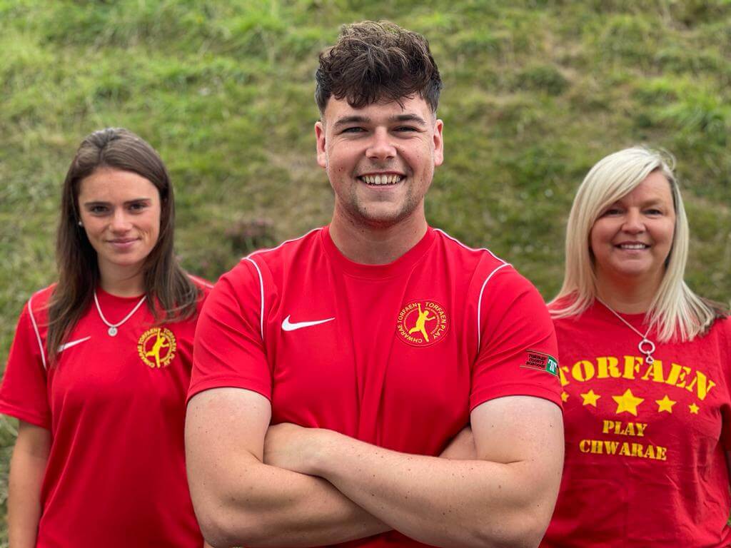 two woman and a man in red t-shirts