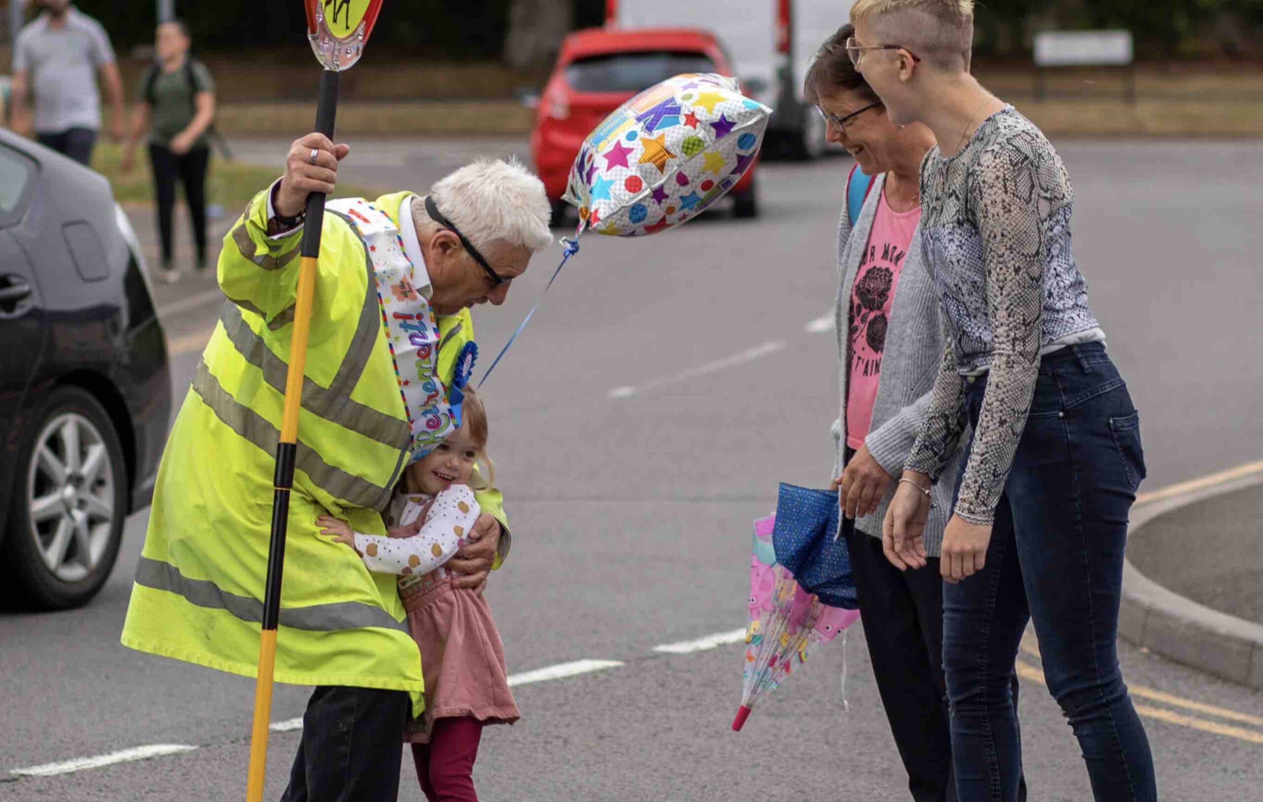 child hugs lollipop man