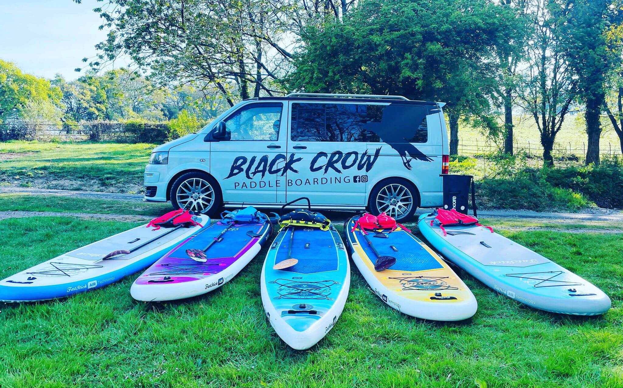 A VW with paddleboards on the floor
