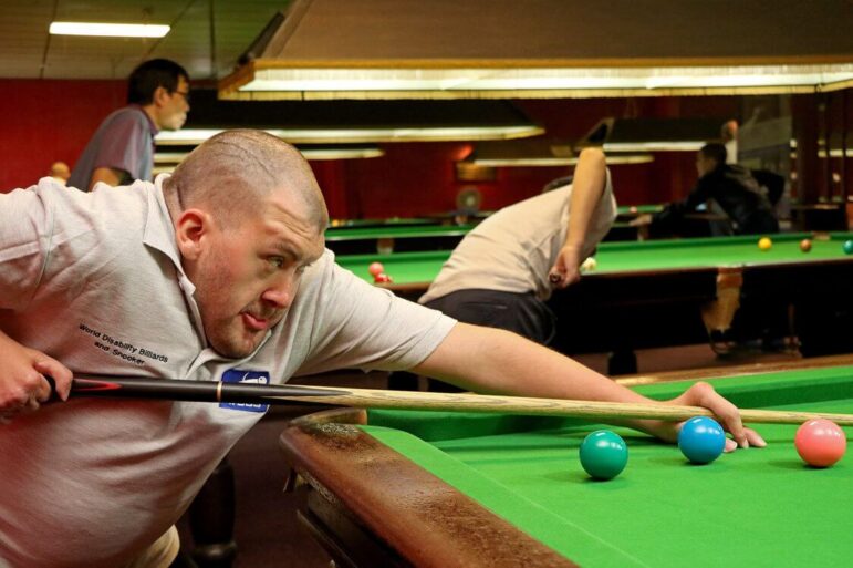 a man playing snooker