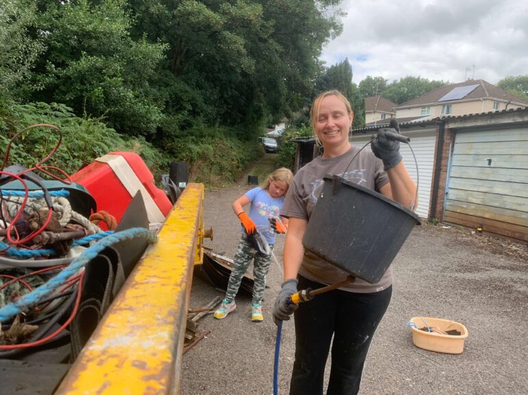 a woman putting things in skip