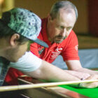 a snooker coach helps a player