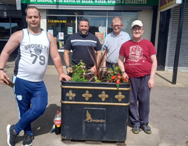 four men by a planter