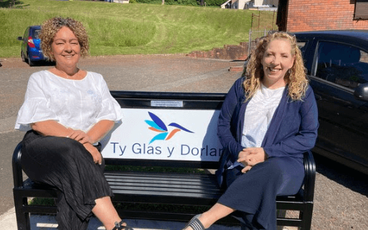 two women sat on bench