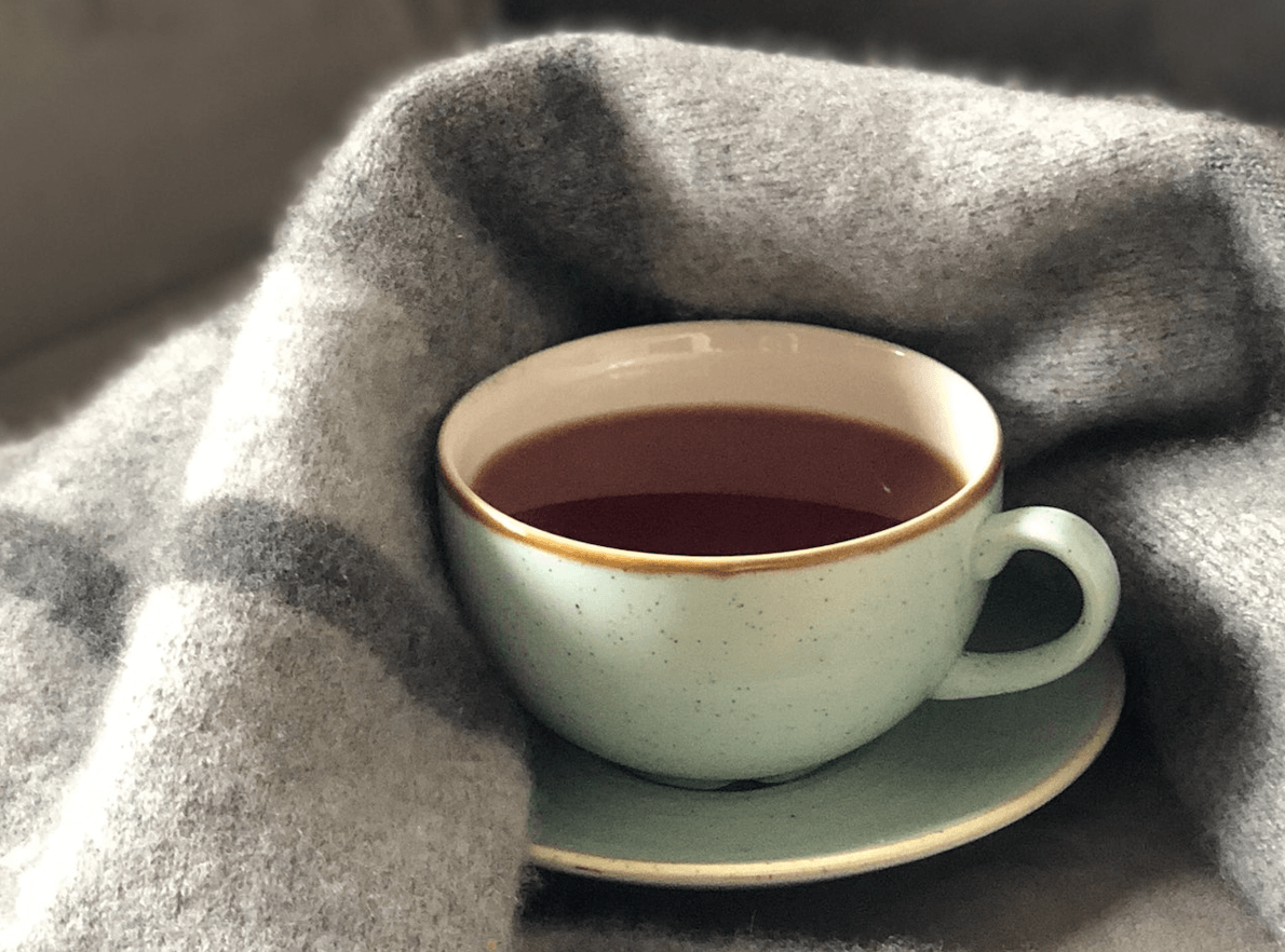 cup of coffee on blanket