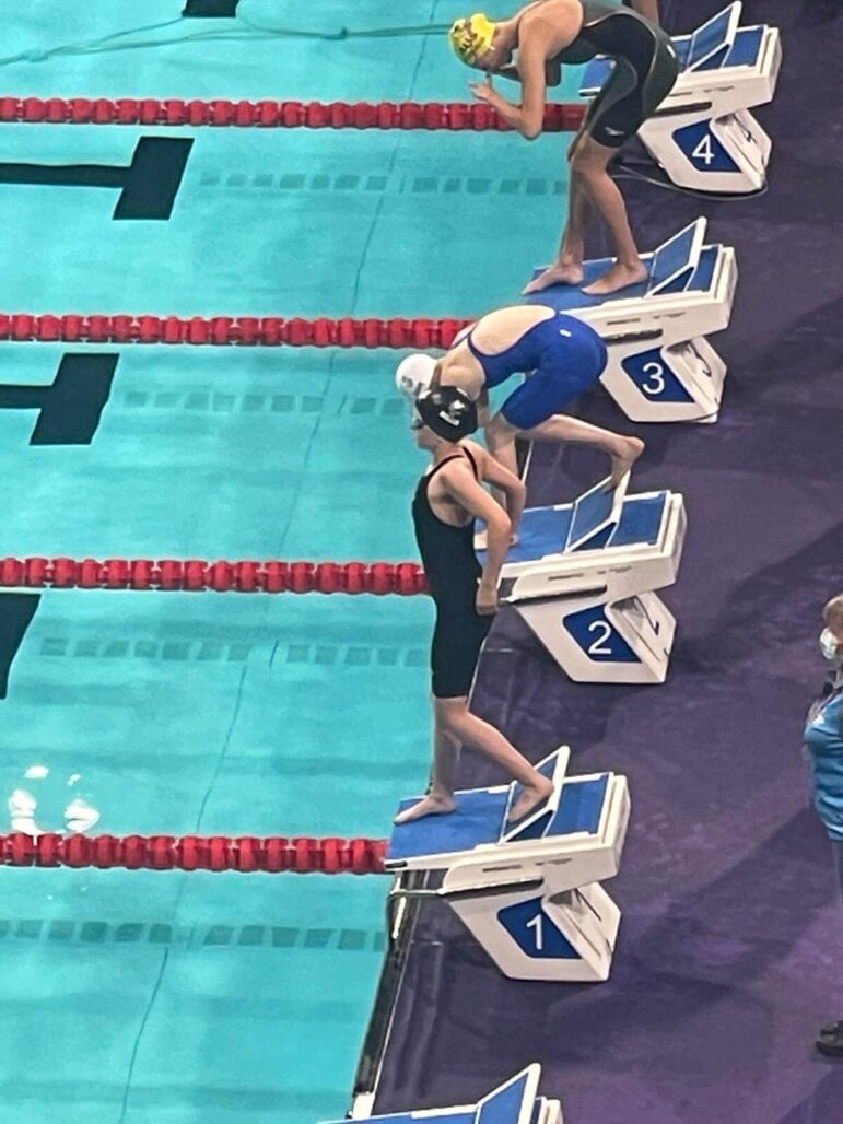 swimmers line up to race