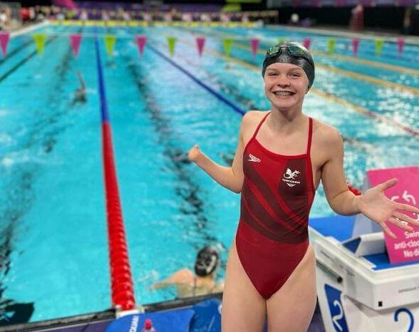 girl stood by swimming