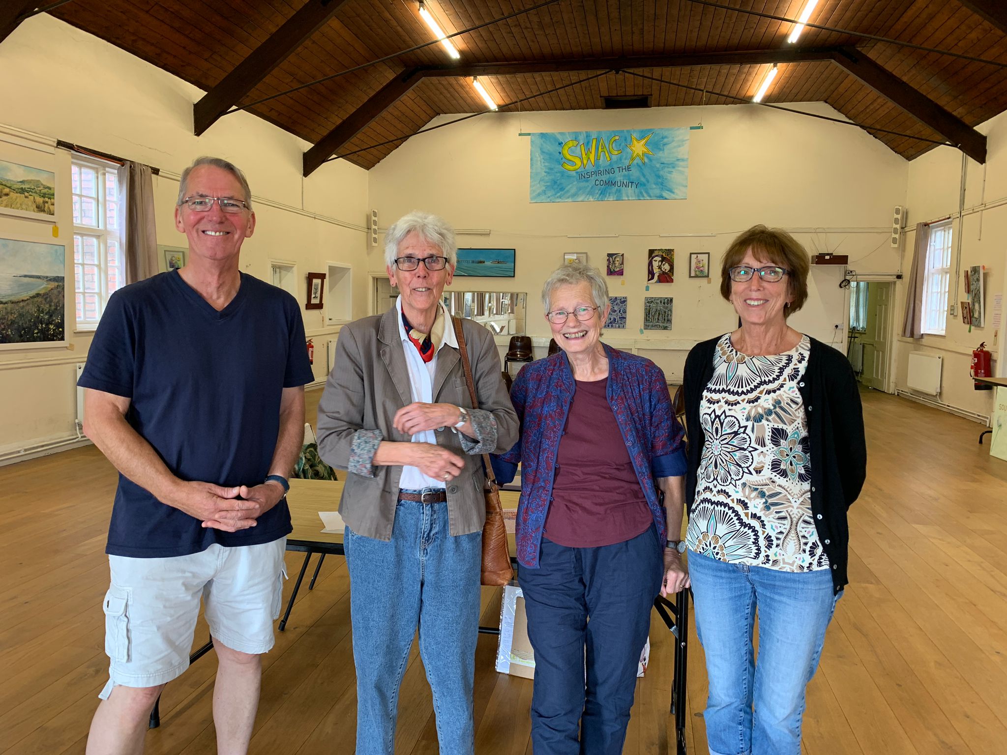 four people in an art gallery