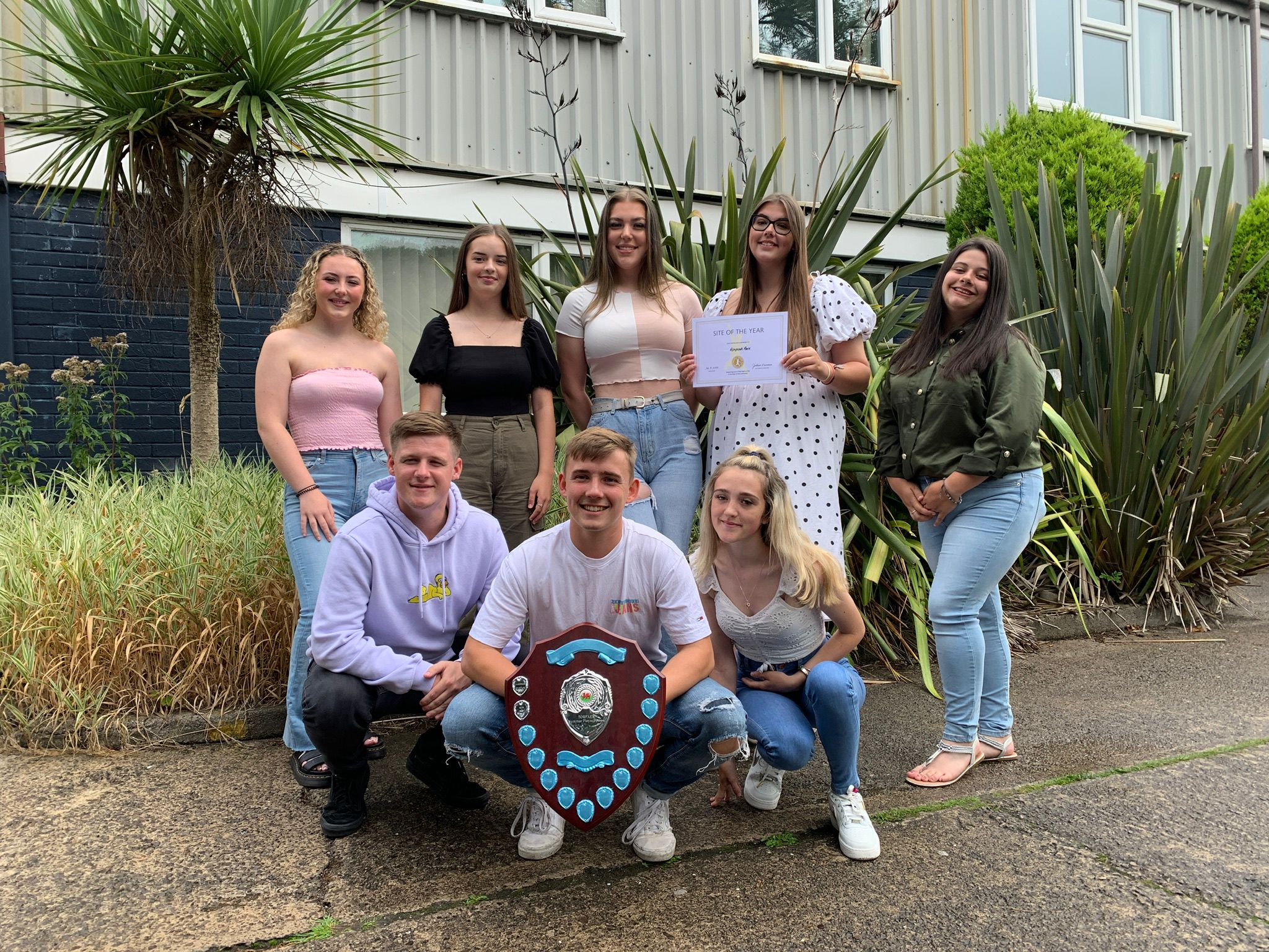 group of people and a large trophy