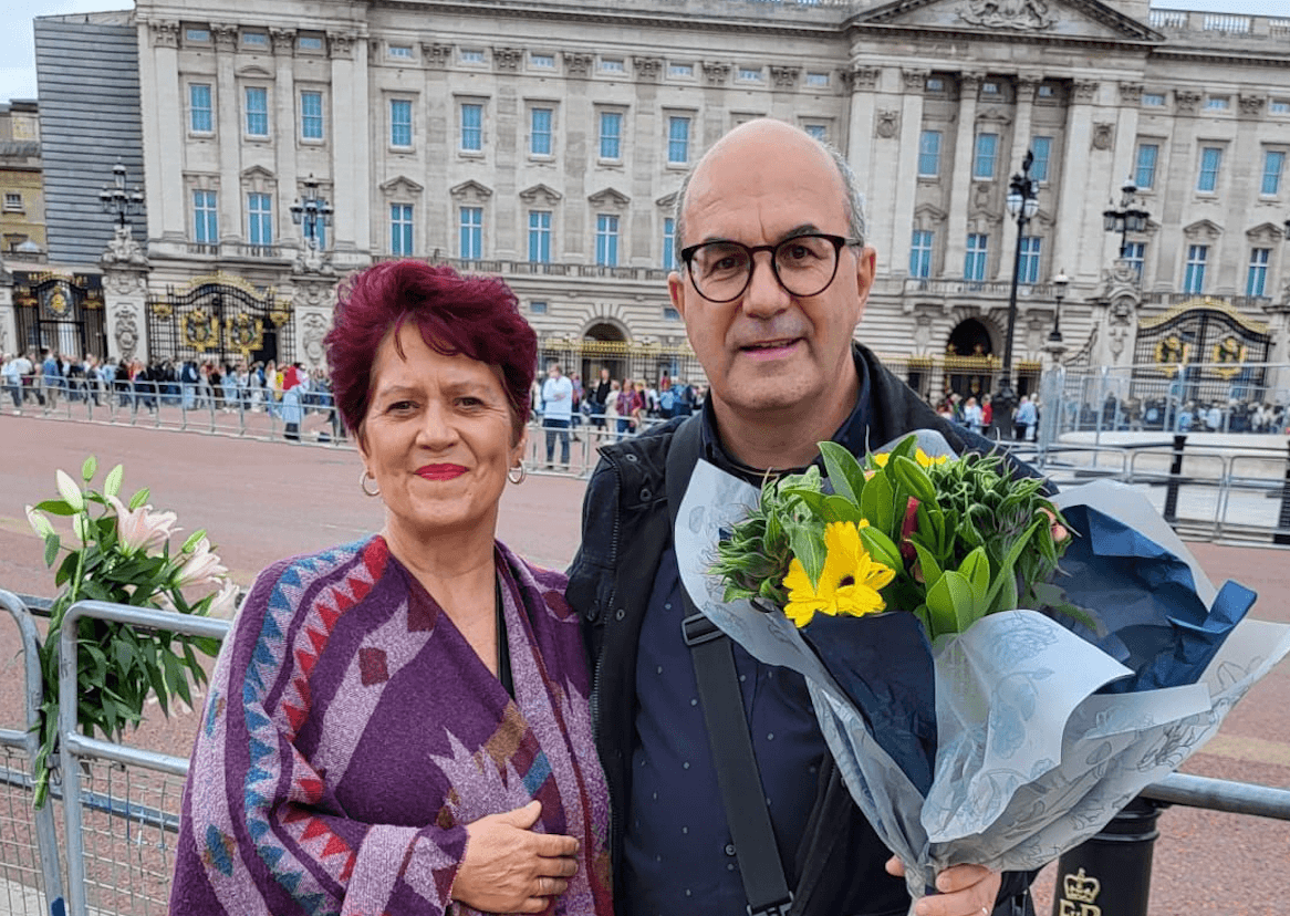 man and woman outside buckingham palace