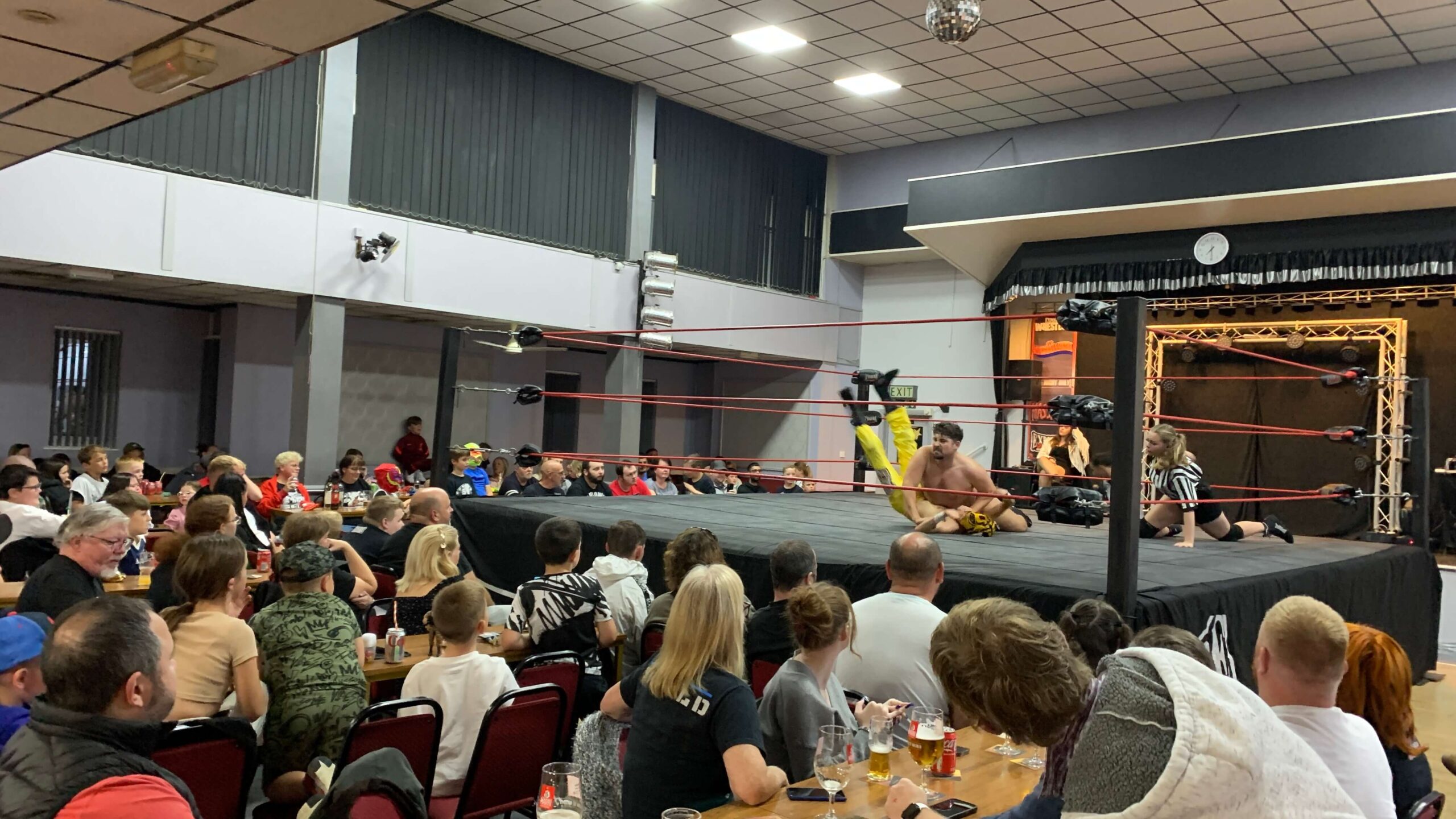 a wrestling match in a packed club