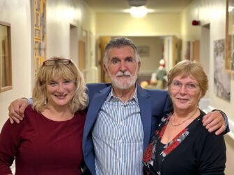 two sisters and a brother smile for photo