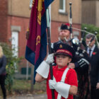 a boy carrying a flag