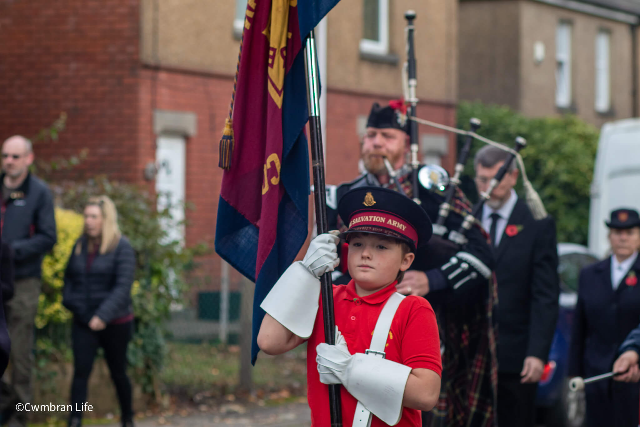 a boy carrying a flag