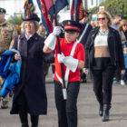 a boy carrying a flag