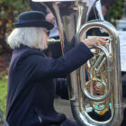a woman playing a tuba