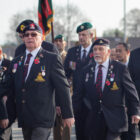army veterans wearing their medals and marching