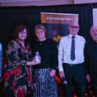 People on stage collect awards