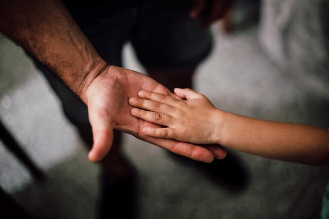 a child's hand in an adult's hand