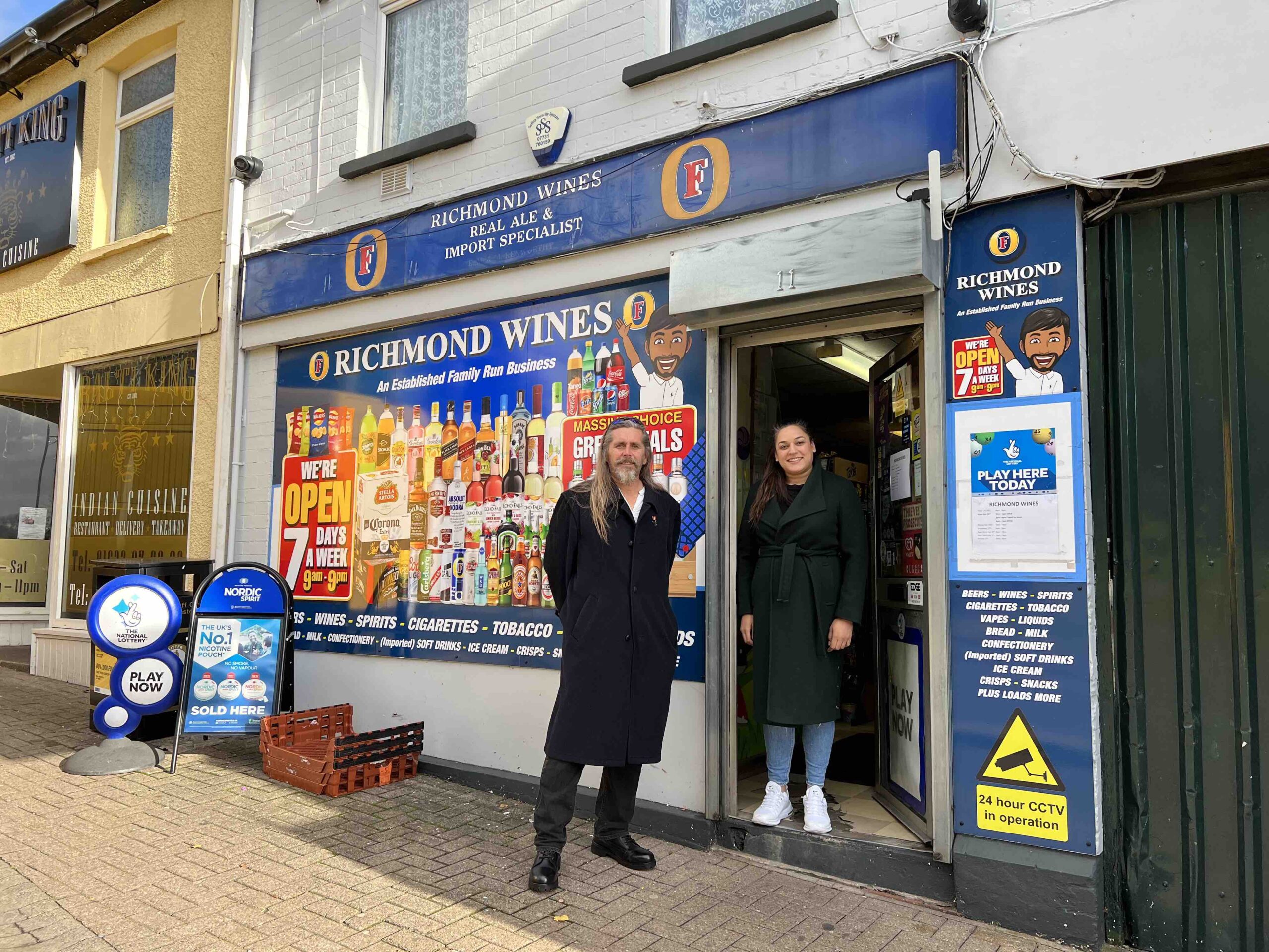 Man and woman stood outside shop