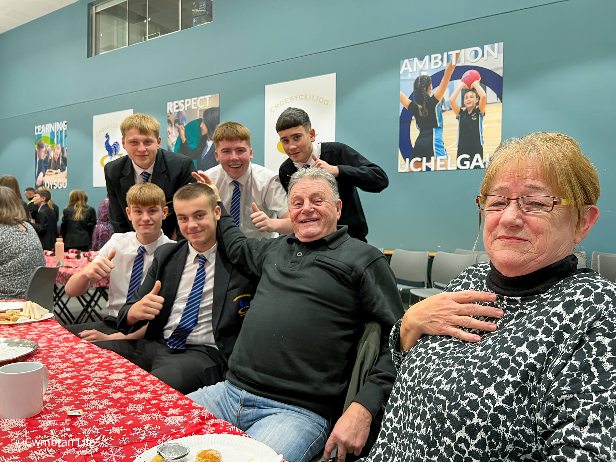 school pupils sat with an older man and woman