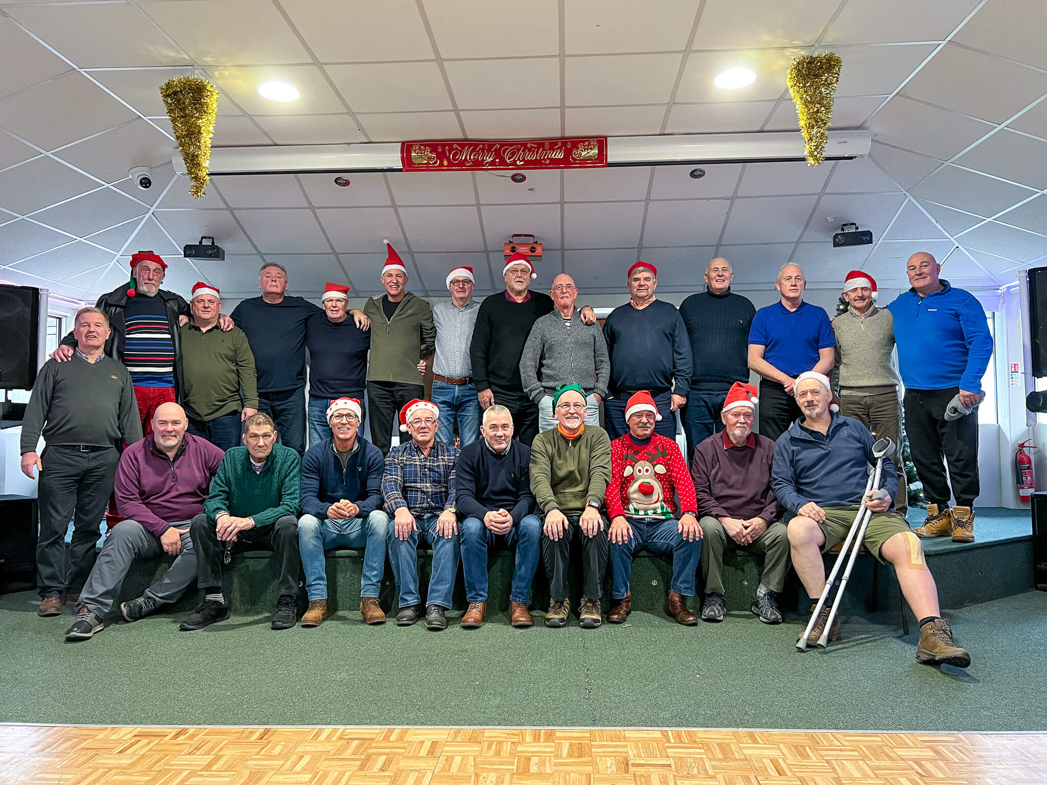a group of former rugby players in a team photo