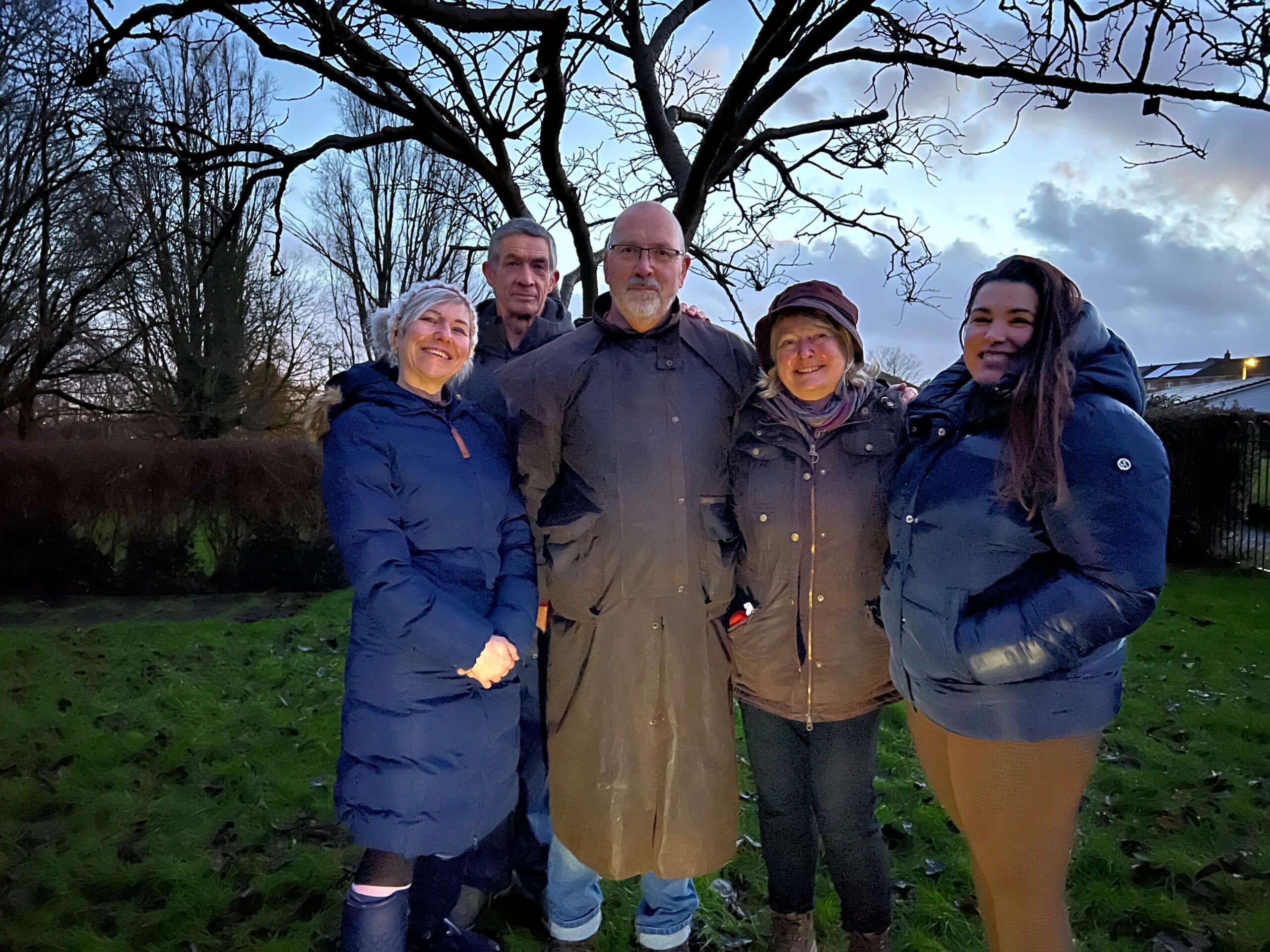 group of people by a tree