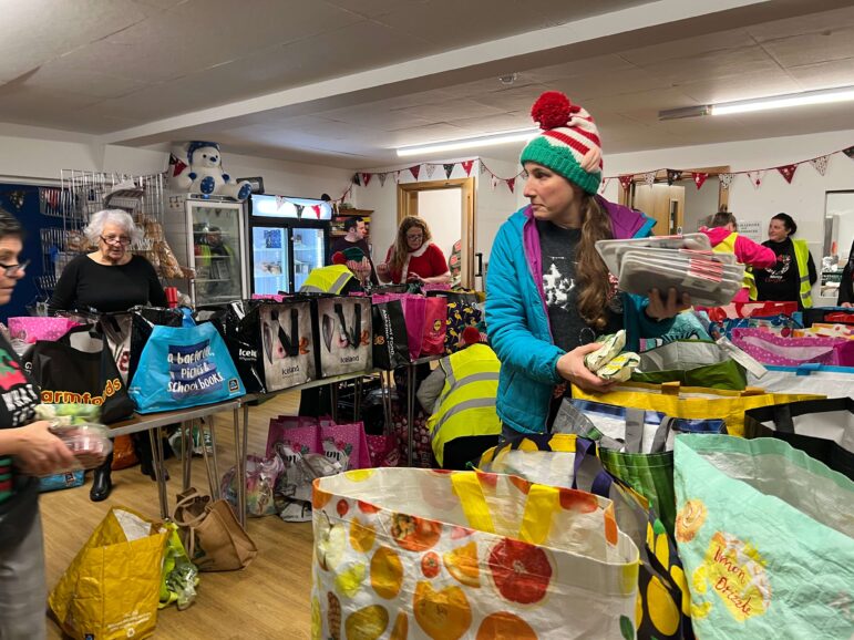 a woman packs a food parcel