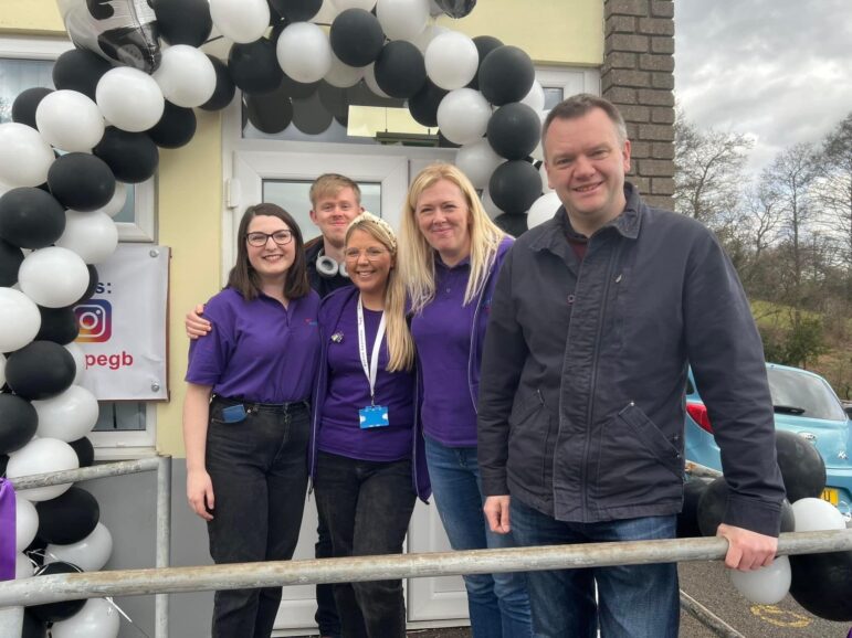 group of people by balloons at opening of new centre